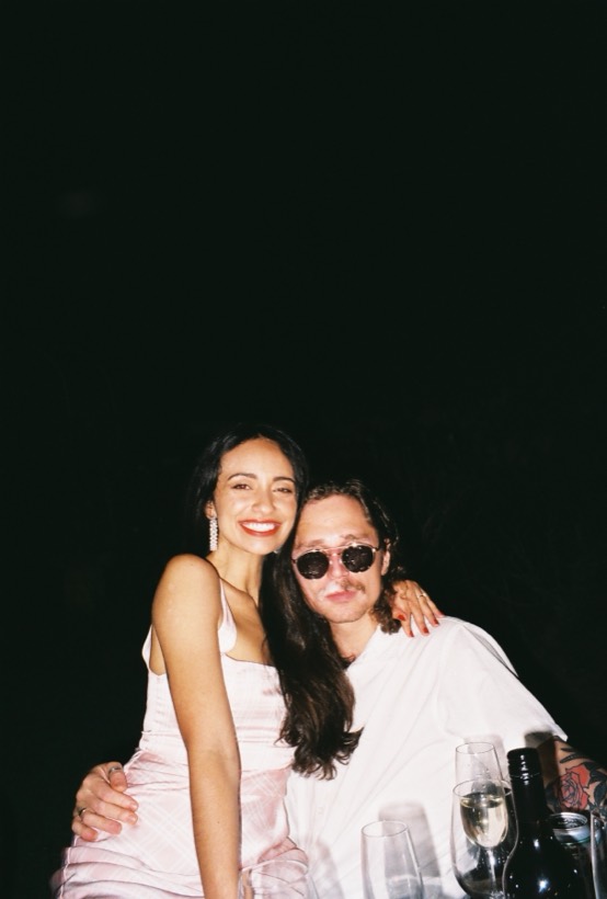 Brittany and Deklan smiling together at a table.