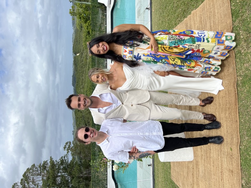 Brittany standing with friends at a bright formal celebration.