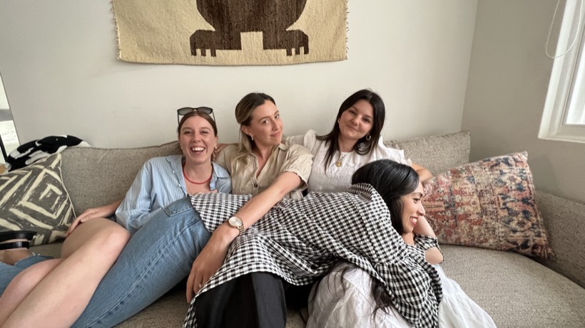 Friends resting together on a couch in a quiet room.